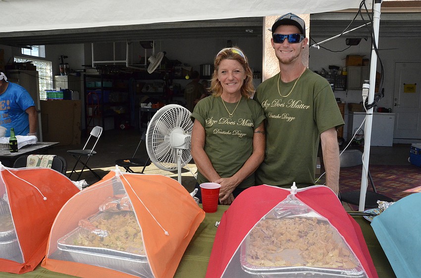 Bradenton residents Becky Kanipe and her son, Craig, help serve food.