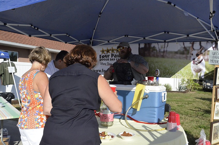 Waterlefe residents Becky Kutska and Jodi Carroll get refreshments from Jason Petty.