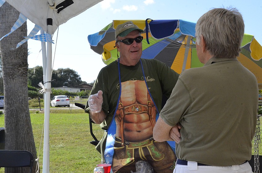 Volunteer Jack Traeger serves up barbecue to Mike Williams.