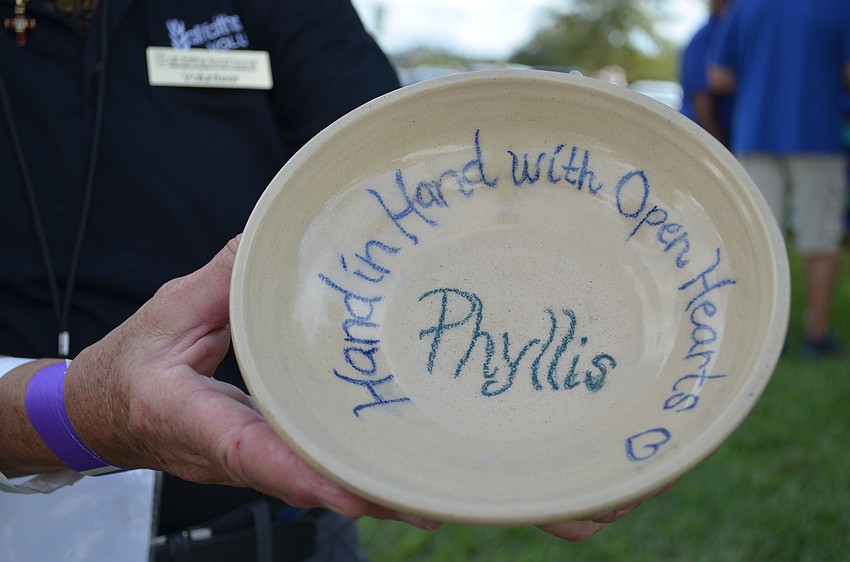 Phyllis Siskel holds a bowl that was made for her by cadets at the Sarasota Military Academy Prep school.
