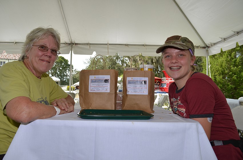 Sue Potter and Izabela Burns with the bags of soup they're taking home for later.