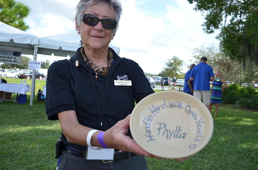 Phyllis Siskel holds the bowl given to her especially by the cadets at the Sarasota Military Academy Prep School.