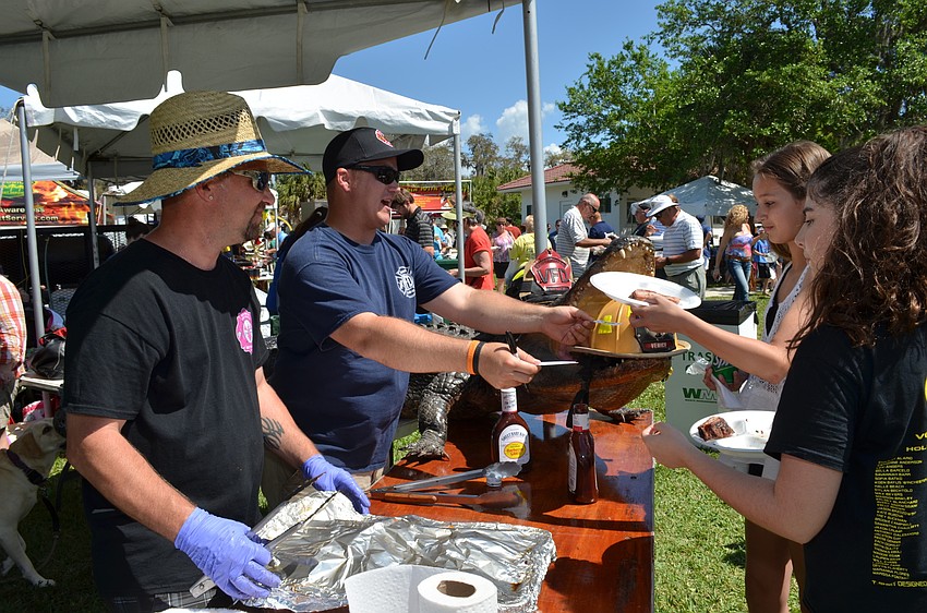 Sam Johnson and Matthew Petitt serve ribs from station Venice Fire Rescue.