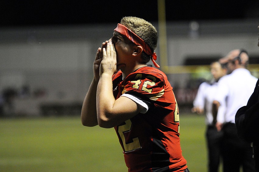 Cardinal Mooney sophomore lineman Cole Purmort cheers on his teammates from the sideline.
