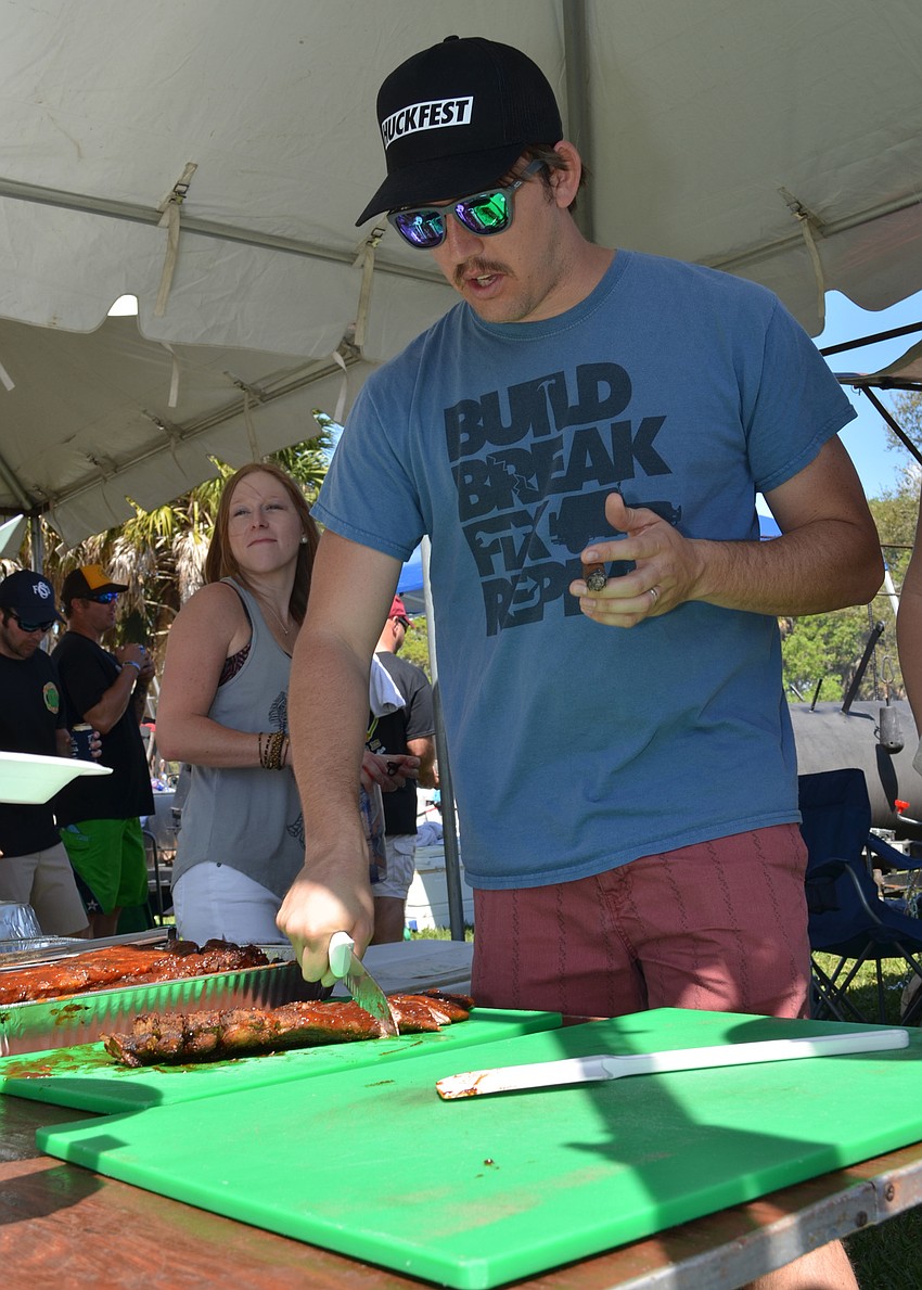 Sean Rowe cuts up samples of ribs.