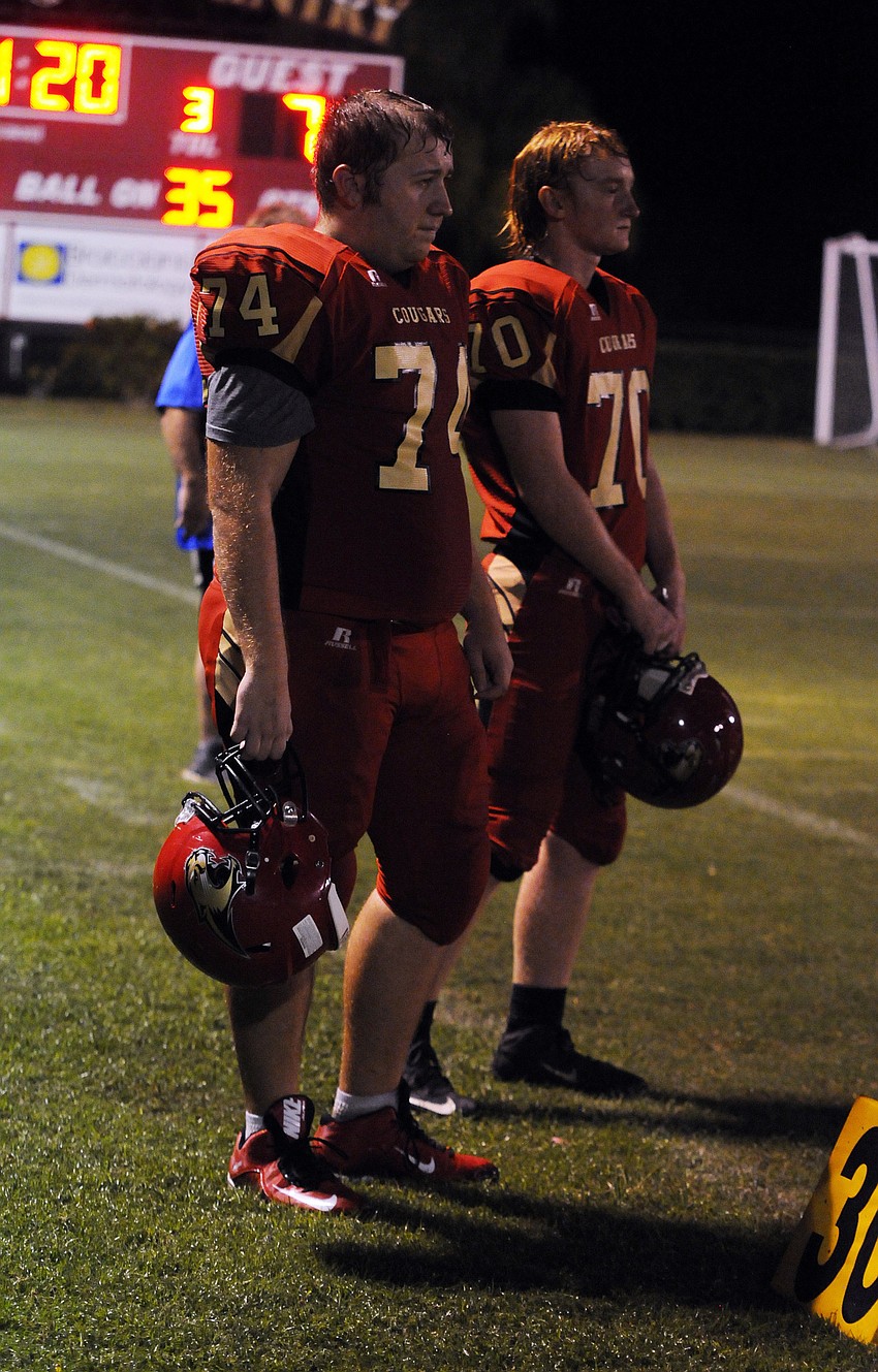 Cardinal Mooney linemen Quinn Campbell and Armando Fontana look on from the sideline in the first quarter.