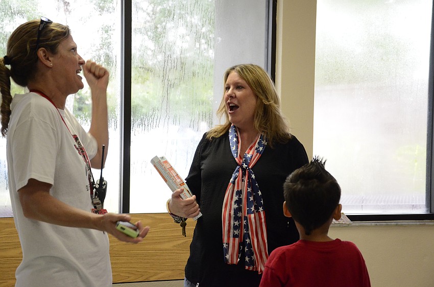 P.E. teacher Amy Teta and first-grade teacher Angie Willett chat after the program.