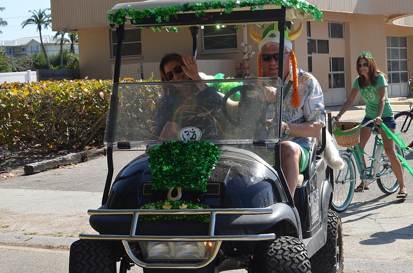 Lucille and David Miller ride along on the parade.