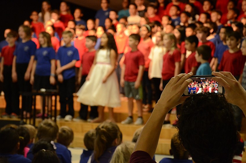 Camille Phillips records her daughter, Gabrielle, during the program.