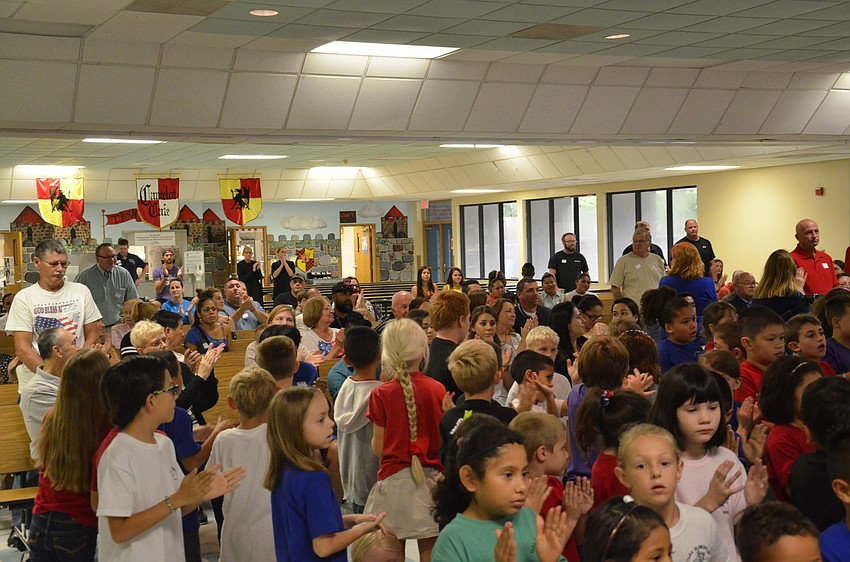 Principal Steve Royce asked all military members in the audience to stand up.