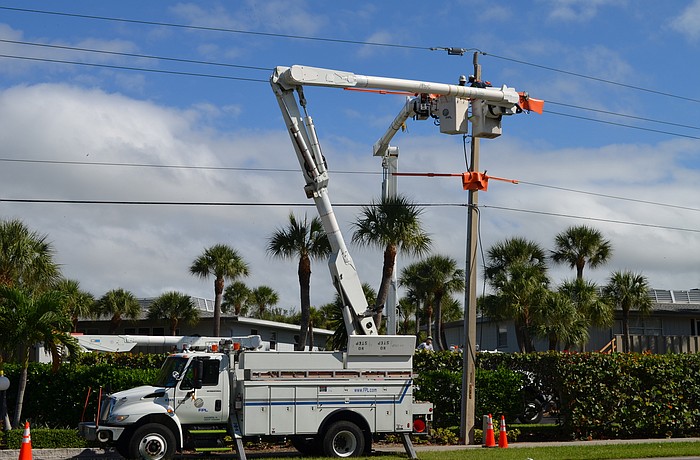 Florida Power & Light Co. crew members work to repair a power line in the 6700 block of Gulf of Mexico Drive Monday in an area that Commissioner Pat Zunz says has frequent power outages that arenâ€™t documented. (Kurt Schultheis)