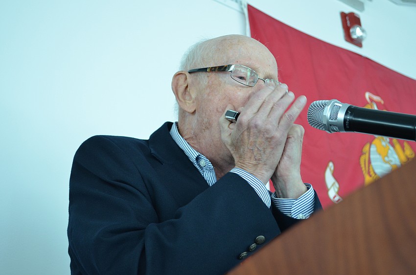 Peter Minotti plays on the harmonica a medley of the 