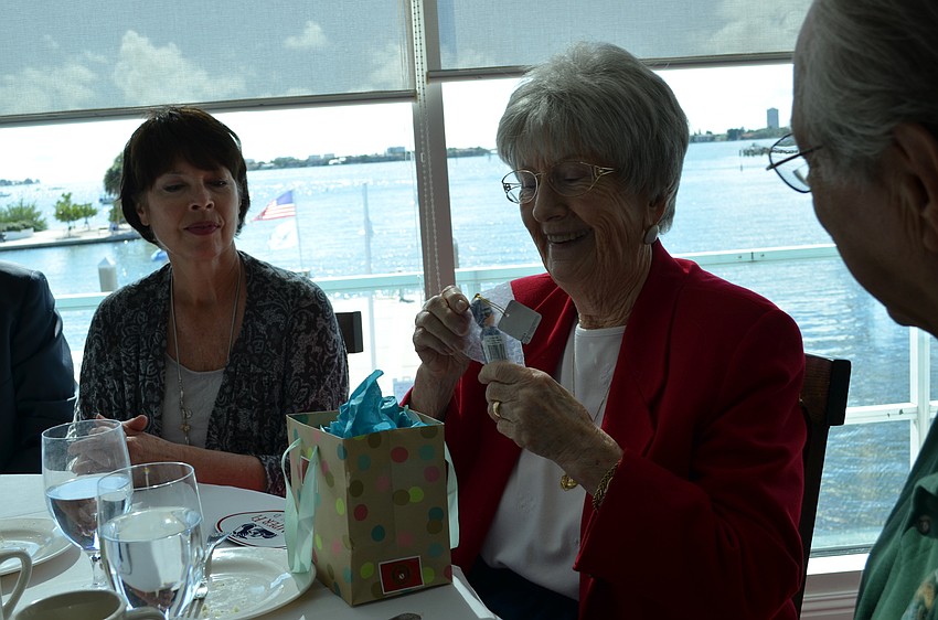 Blanche Mettler unwraps a gift from Tom Smith for her services.
