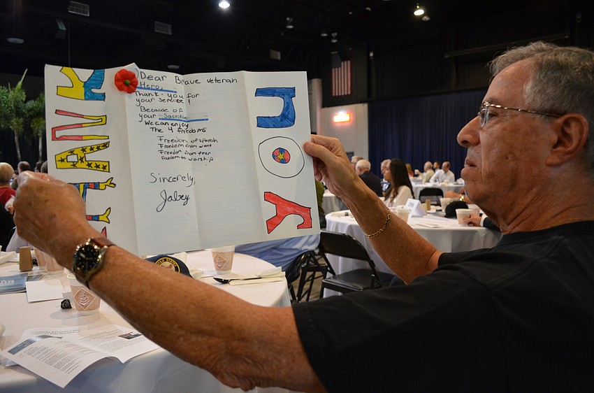 Marti Donner reads a thank you card from students at McIntosh Middle School.
