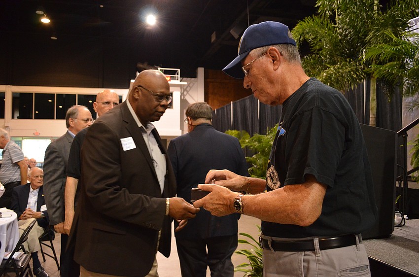 Mayor Willie Shaw receives his pin from Marti Donner for serving during the Vietnam War.