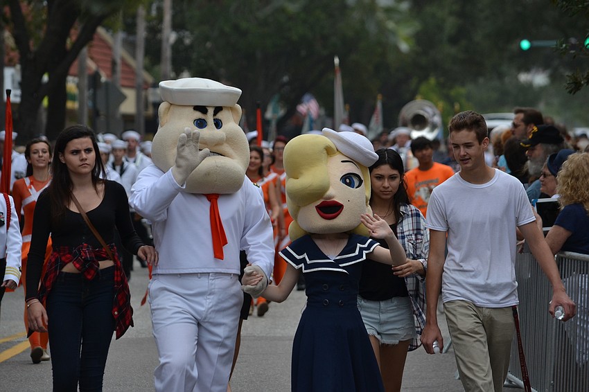 Sarasota High School mascots wave at parade goers.
