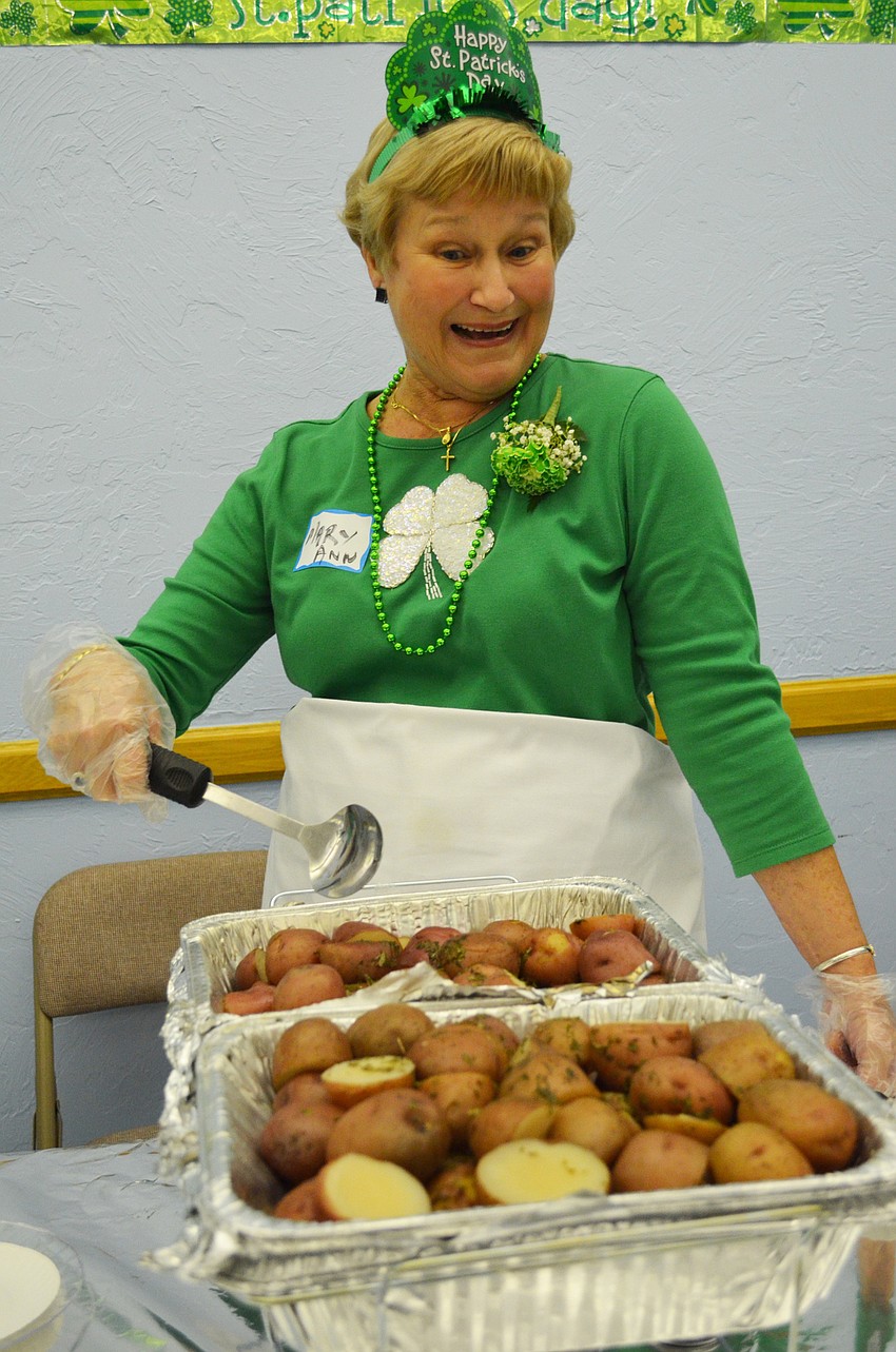 MaryAnn Simpson serves up red potatoes.