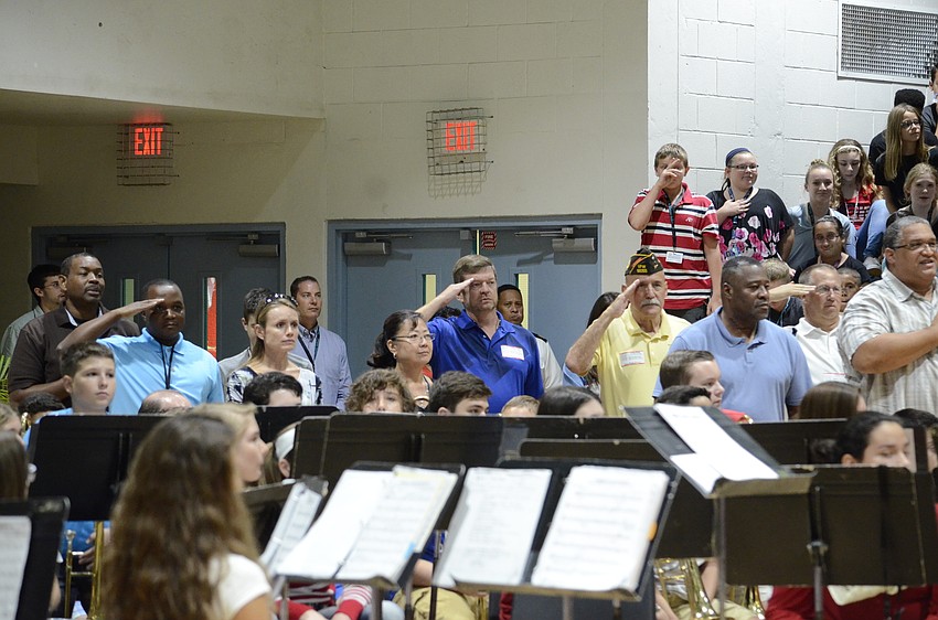 As the choir sang the Star Spangled Banner, veterans in the audience stood and saluted.