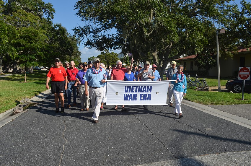Vietnam War era veterans march in the parade.