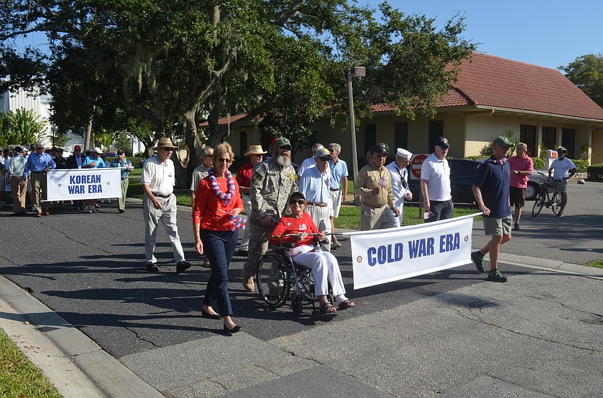 Cold War era veterans march in the parade.