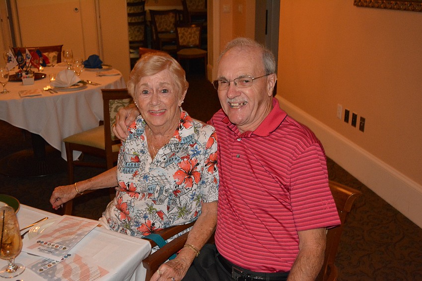 Carol Finnegan and Navy veteran Lenny Rounds listen to the band during the Veterans Day Dinner & Dance at Tara Golf & Country Club on Friday.