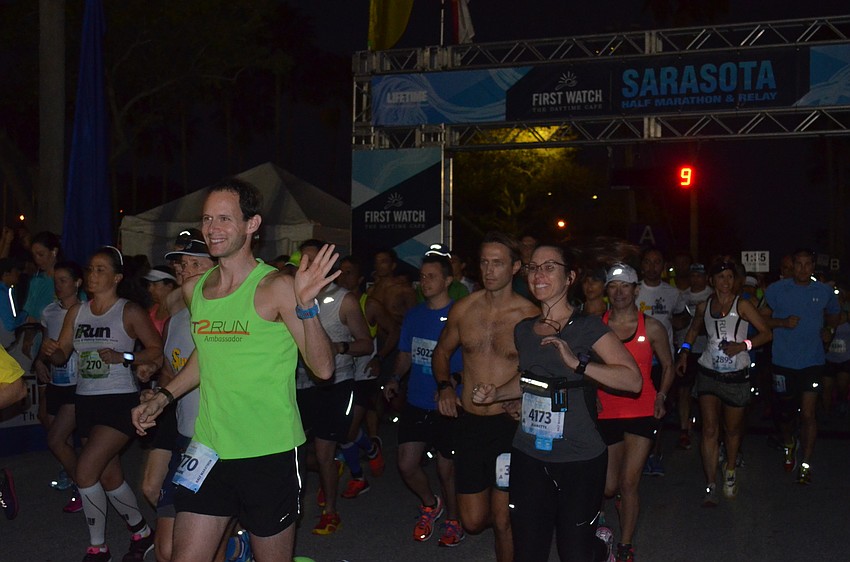 Runners cross the start line.