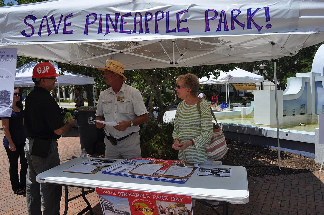 Sarasota Farmers Market Manager Phil Pagano, center, and Save our Sarasota leader Jude Levy manned a booth at the marketâ€™s â€œSave Pineapple Parkâ€ day in July. The market will hold another event focused on Pineapple Park this Saturday.