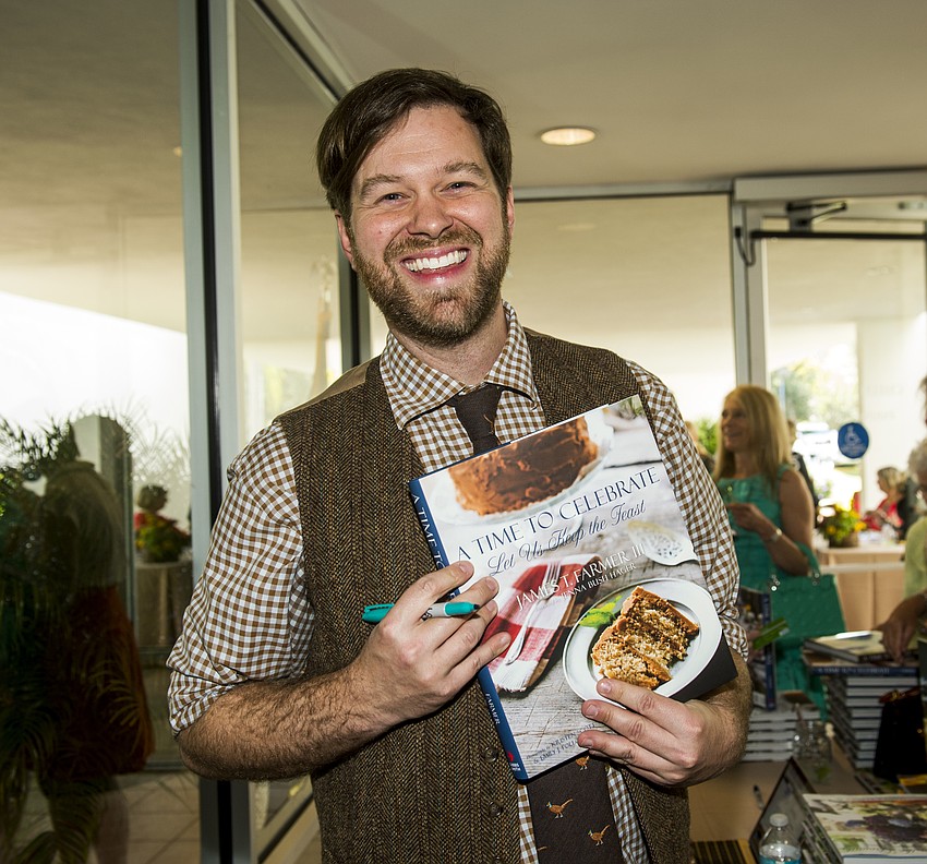 James T. Farmer III with his book 