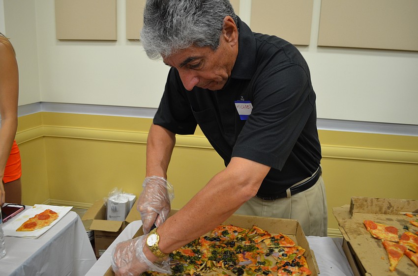 Michael Pitoniak helps serve up slices of pizza from Il Panificio.