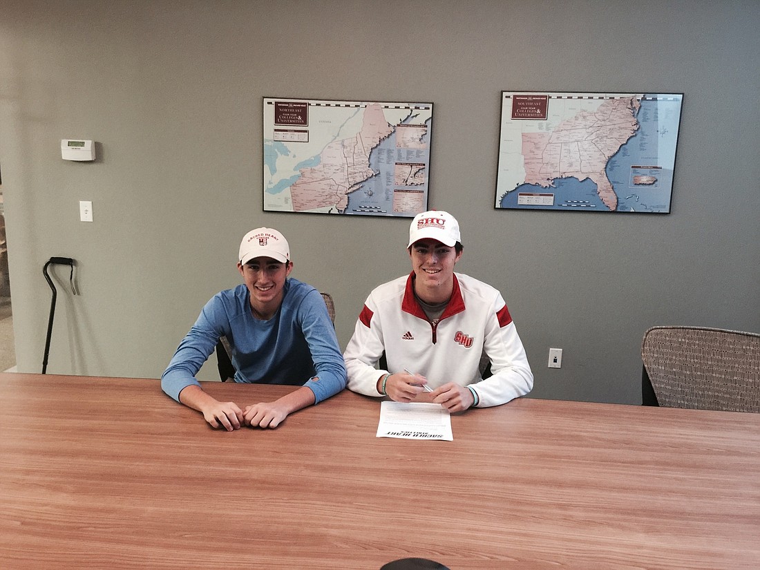 With his younger brother Drew Bavaro by his side, Vito Bavaro, right, signed a national letter-of-intent Nov. 11 to play hockey for Sacred Heart University.