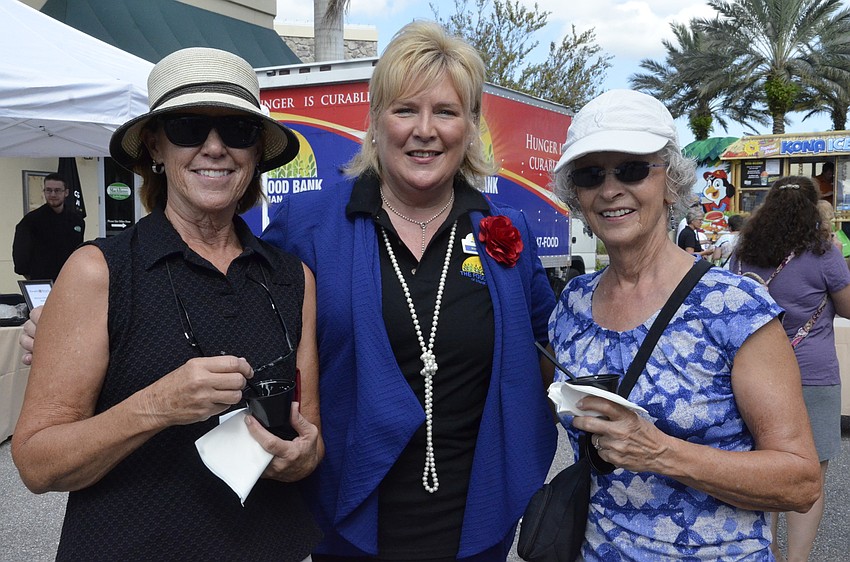 Riverstrand resident sEllen Kibbe, left, and Celeste Betjemann, right, with Food Bank CEO Maribeth Phillips