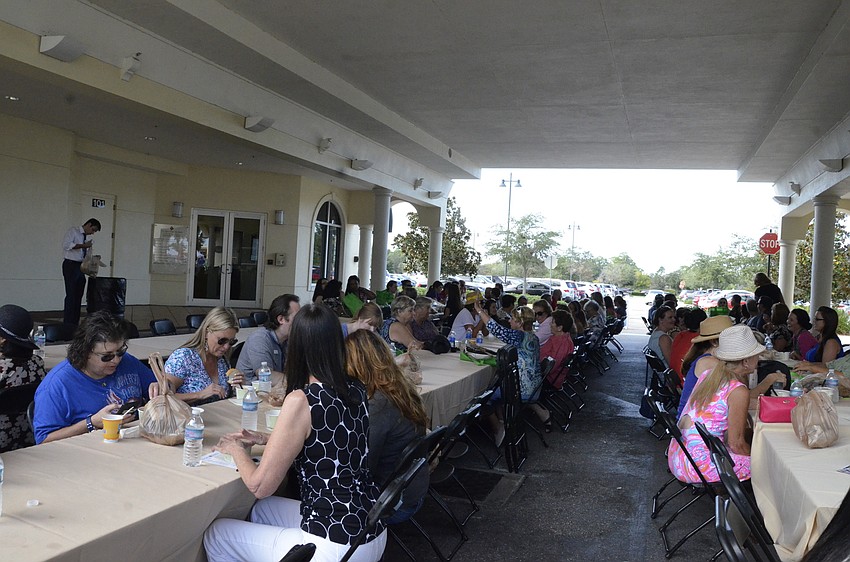 Fundraiser attendees sit down to enjoy their soup selection .
