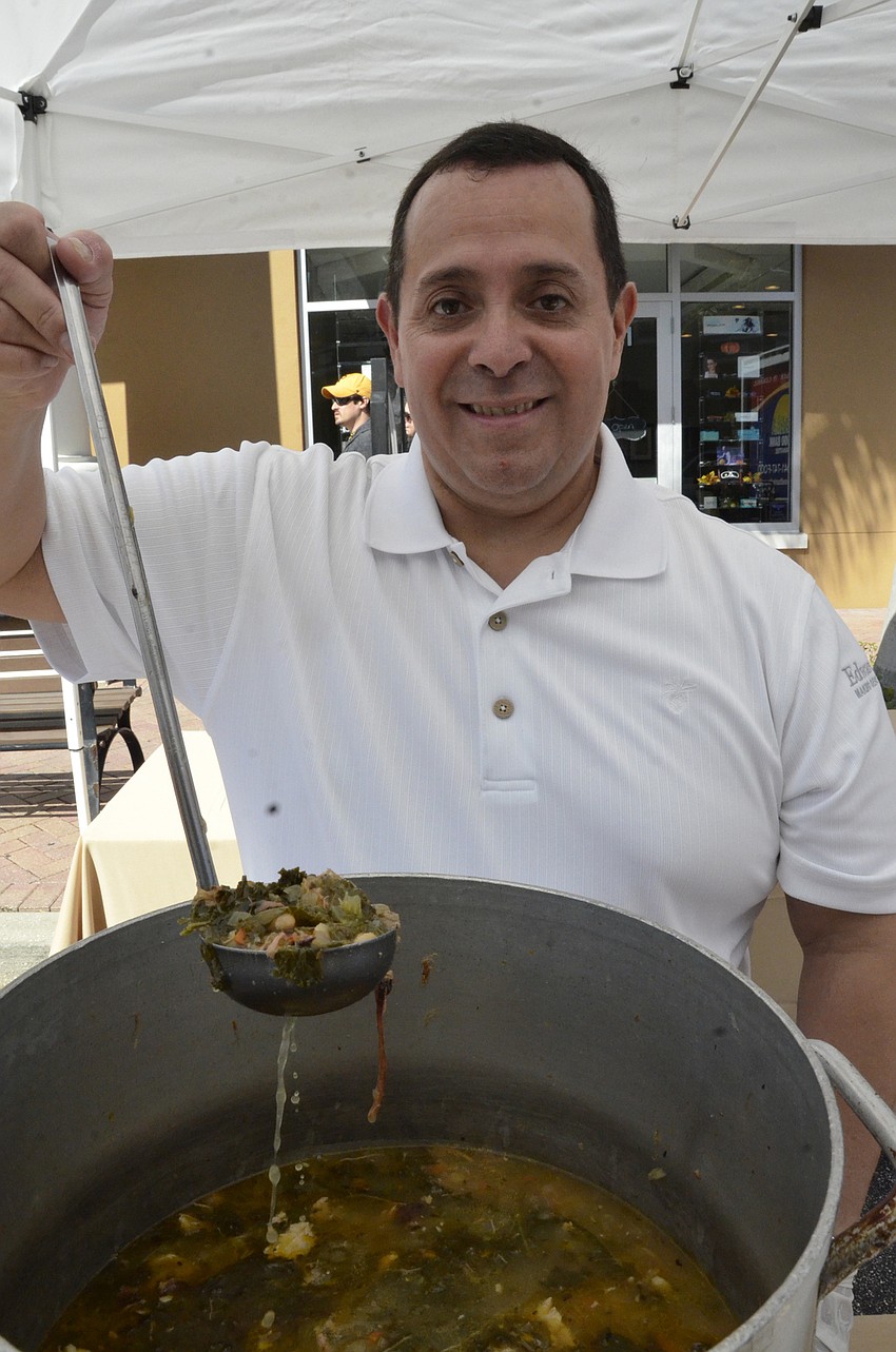 Ron Valdez, a volunteer with Edward Jones, serves up some Morton's Gourmet Market BBQ beef soup with kale and white beans.
