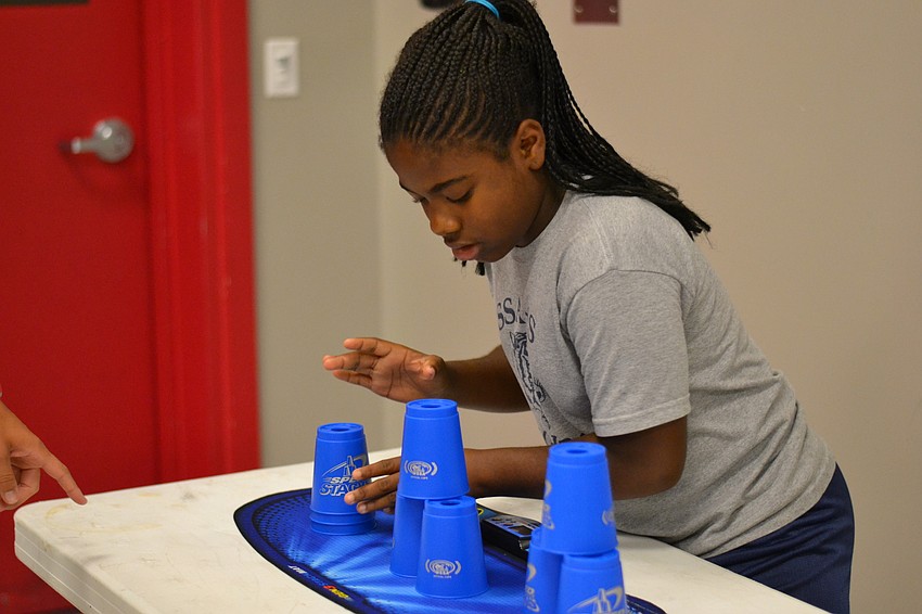Aziya Finley works against the clock to stack cups.