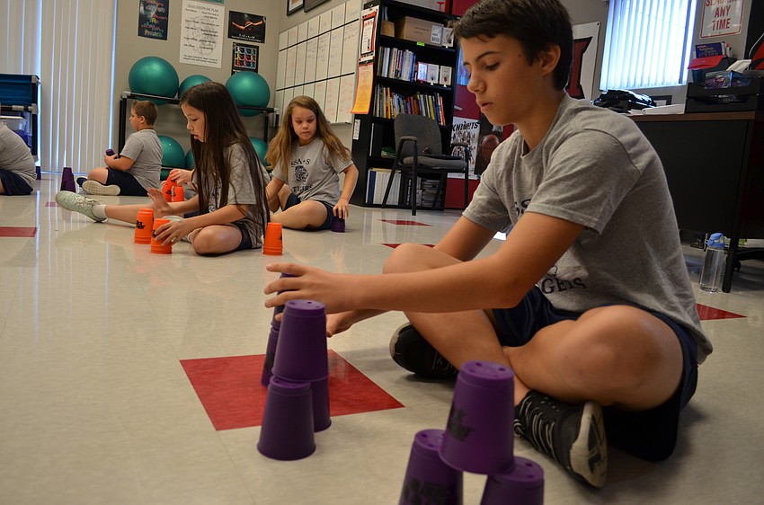 Justin Pugliese demonstrates how to do a 3-6-3 stack with three pyramids of cups.