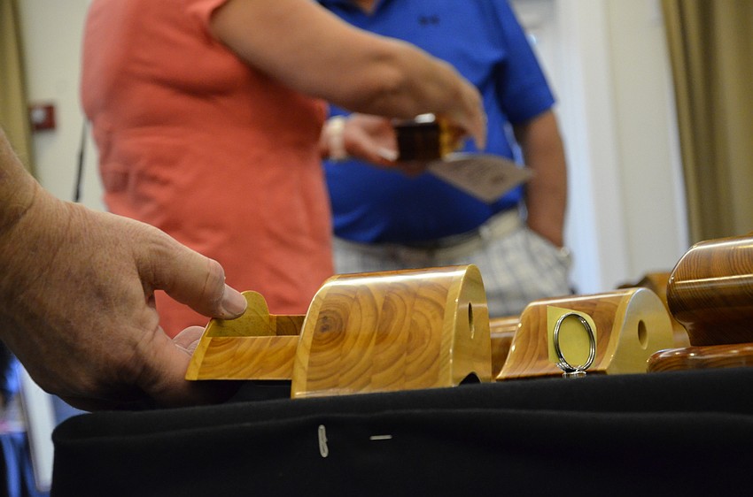 Art Stadlin of Bradenton checks out a wooden box made by Harry Bandish.