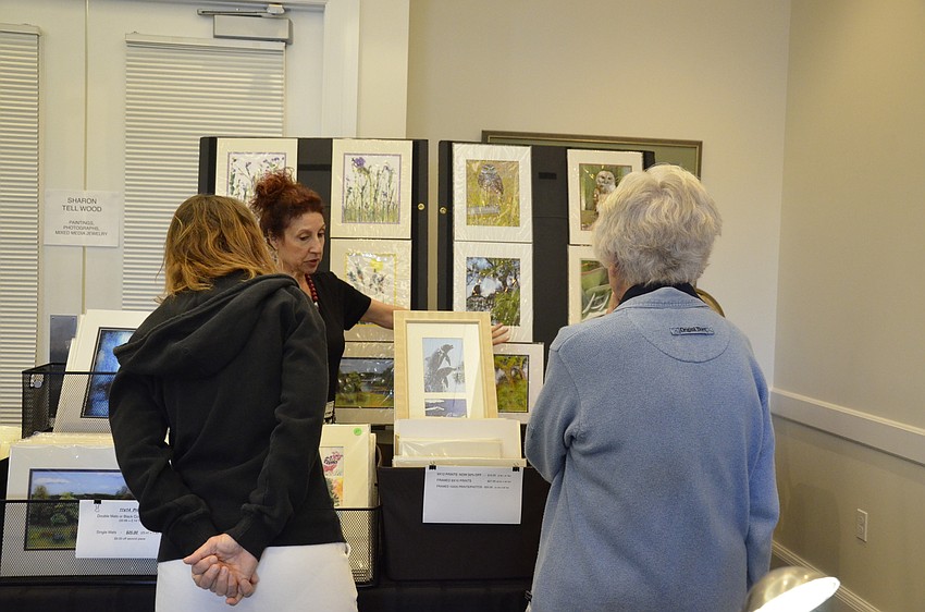 Elaine Walker and her mother, Dorothy Lamalie, a Moorings resident, talk with Sharon Tell Wood about her photography.