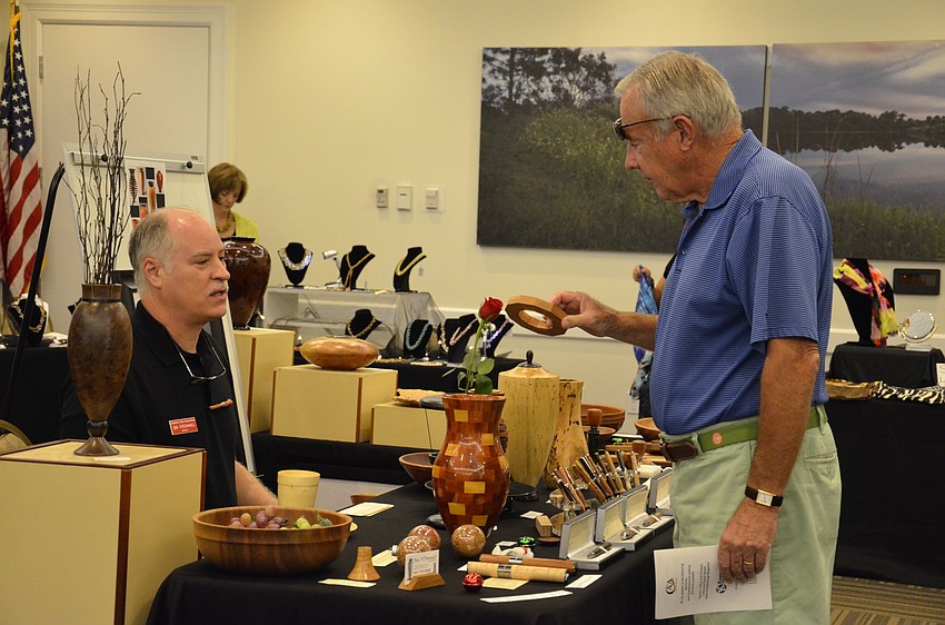 Jim O'Donnell, owner of Wood Turned Art, talks with Charlie Eschmann, a Lakewood Ranch Country Club resident.