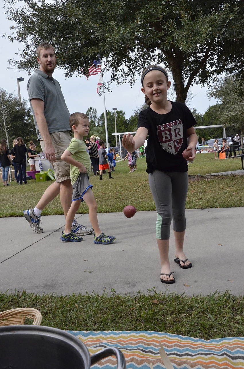 Eva Dyer throws a potato for the potato toss.
