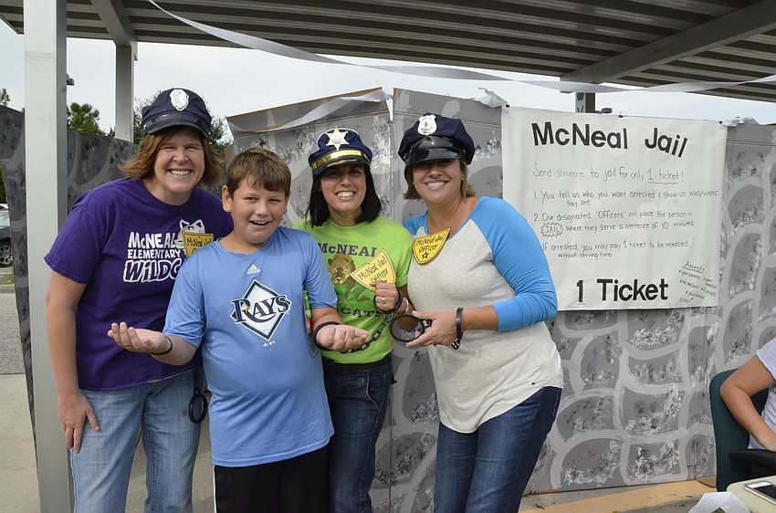 Teachers Gwyn Ingham, Dawn Schmid and Stacy Freeman put fourth-grader Michael Kasper in 