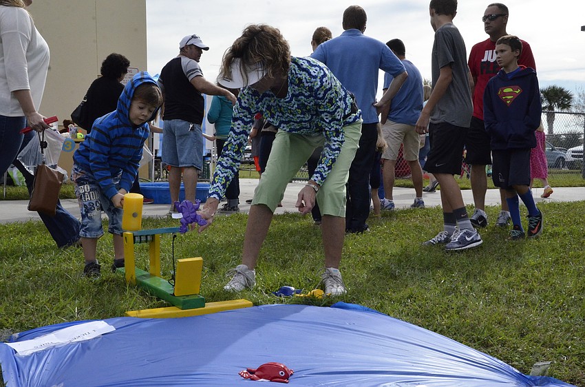 Matias Cordoba launches a frog with technology teacher Denise Touchberry's mini catapult.