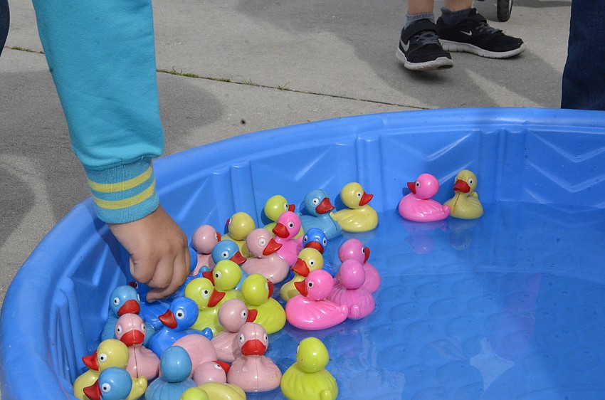 Mia Diaz reaches for a duck to win a prize.
