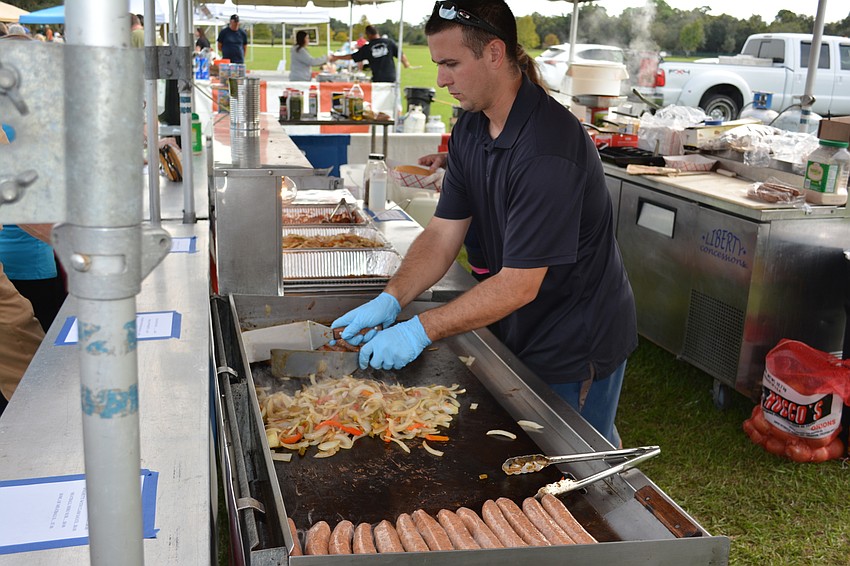 Jimmy Pulver, who worked a booth at Festa Italiana in Greenbrook on Saturday, cooks sausage, onions and peppers.