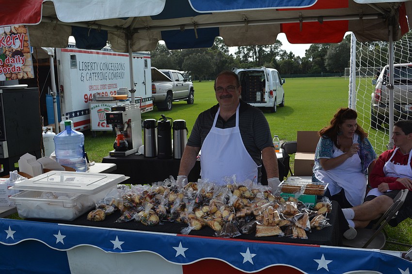Nino Ledi, the owner of Nino's Italian Bakery of Punta Gorda, stands in front of a mountain of Italian cookies at Festa Italiana on Saturday in Greenbrook.
