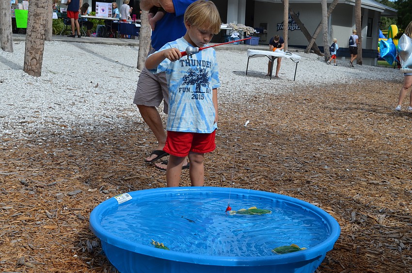 Caiden Bosek hopes to reel in a prize from the fishing game.