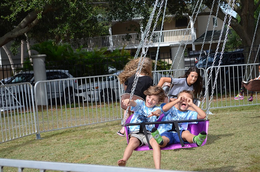 Cash Murphy and Harrison Phillips make goofy faces on the swing ride.
