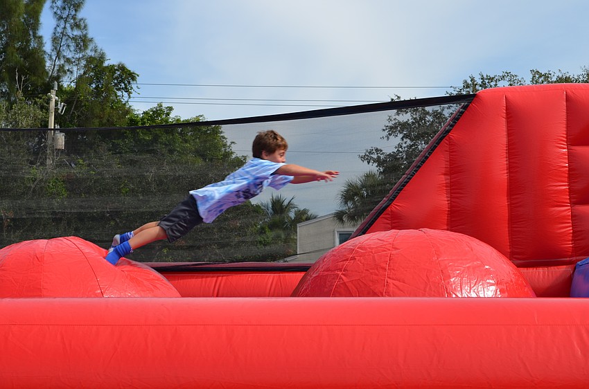 Drew Smith leaps across an obstacle course.