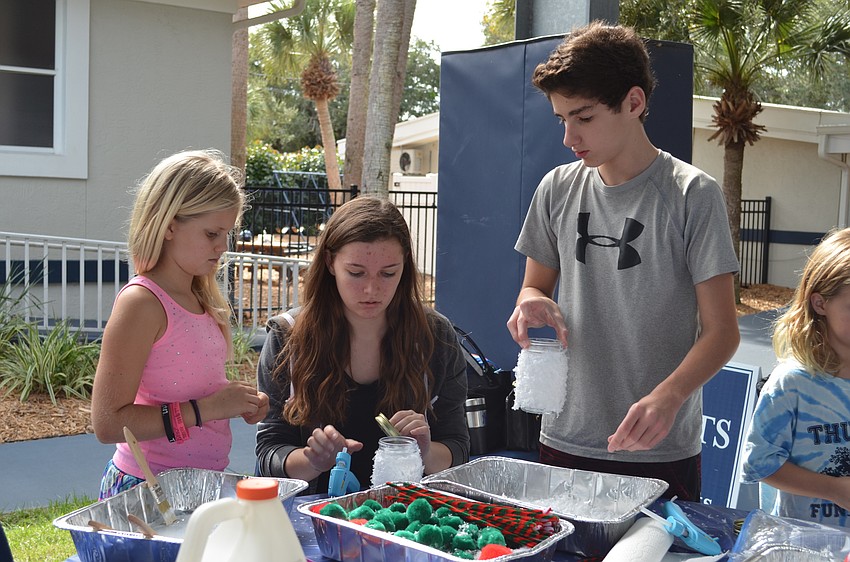 Kinsey Newhams and John Colosimo give a hand with crafts.