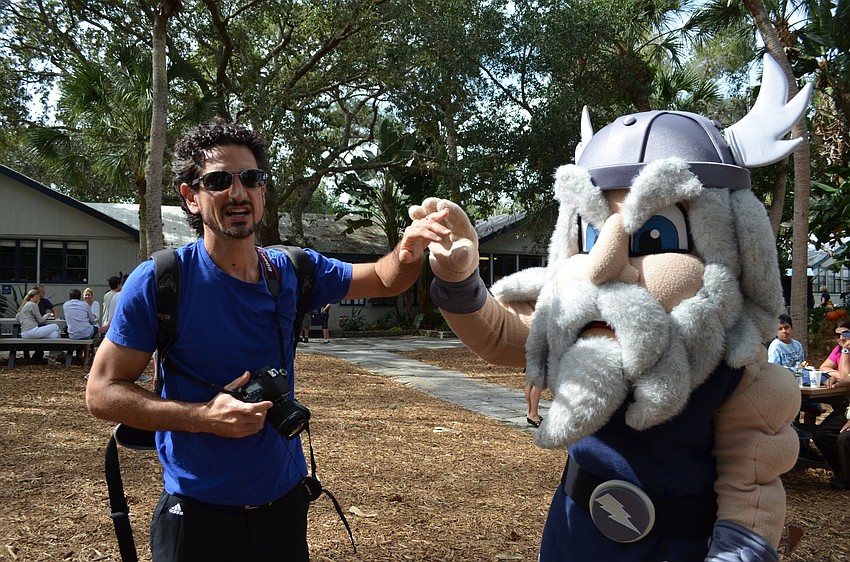 Mario Oliva gives a high-five to ODA mascot Thor.