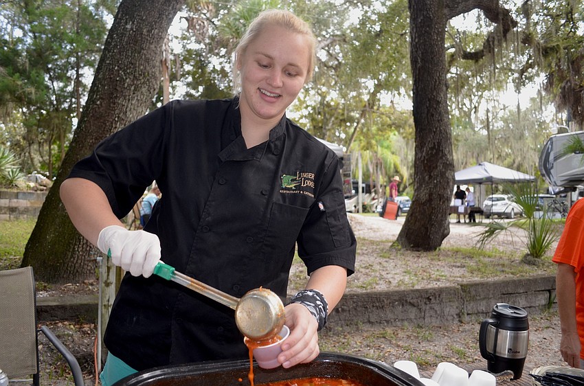 Jami Rowell, of Bradenton, serves Linger Lodge's gumbo recipe — a mixture of tomatoes, okra, sausage, chicken, shrimp and other ingredients.